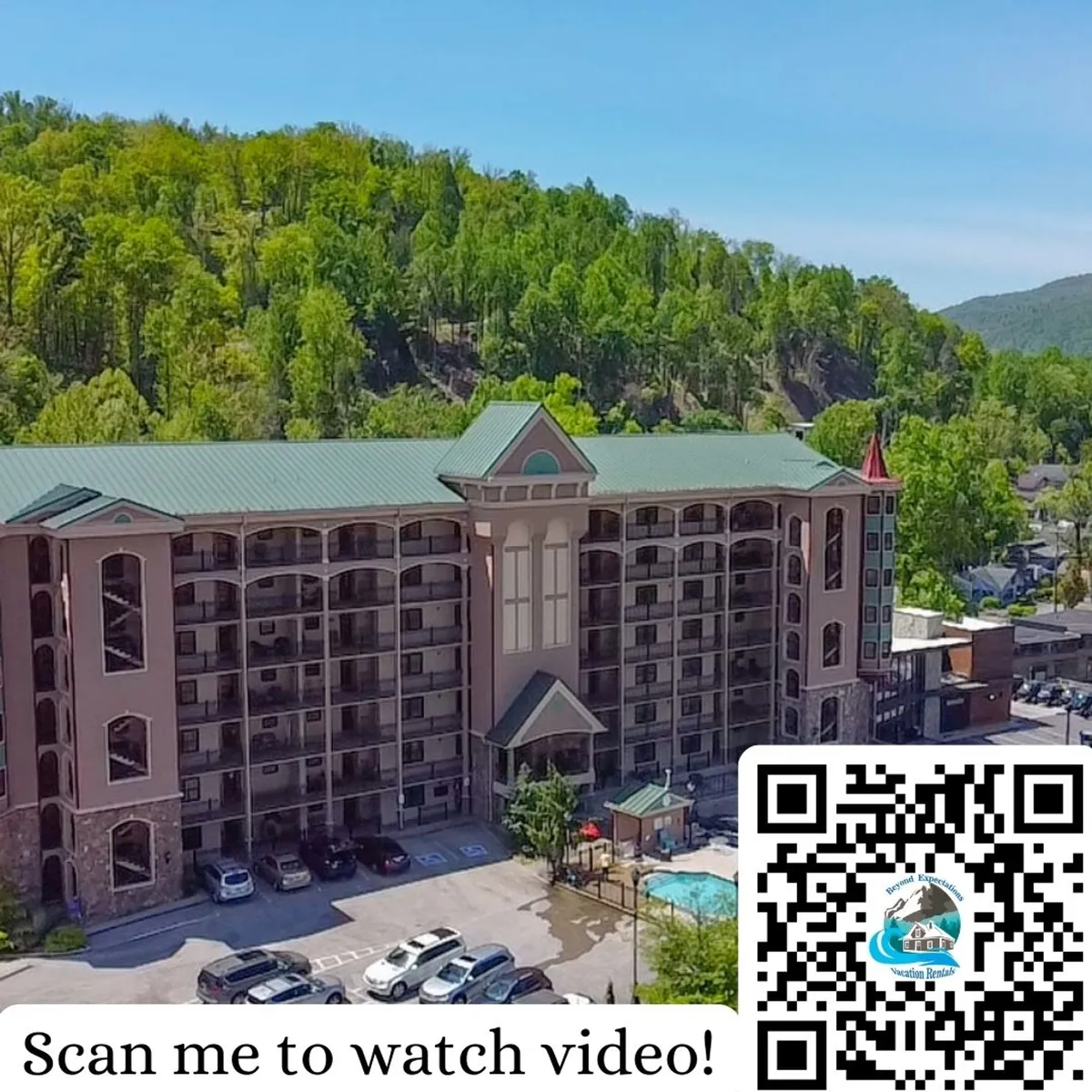 A sunny view of the hotel exterior, featuring a lively pool area surrounded by comfortable seating and lush greenery. The inviting swimming pool is central, with families relaxing and children playing nearby. The backdrop of Smoky Mountain trees ties the property to its natural setting.